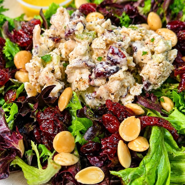 Chicken salad with cranberries and almonds on a bed of mixed greens.